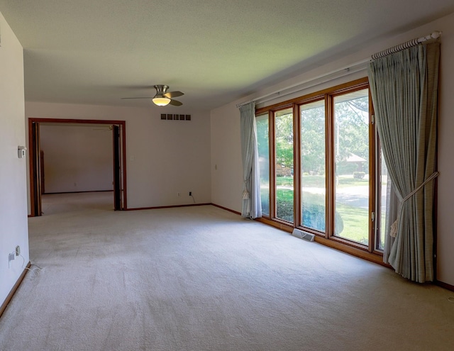 1108 Hillcrest Ct, Chariton, IA 50049 - spare room featuring light carpet, plenty of natural light, and ceiling fan