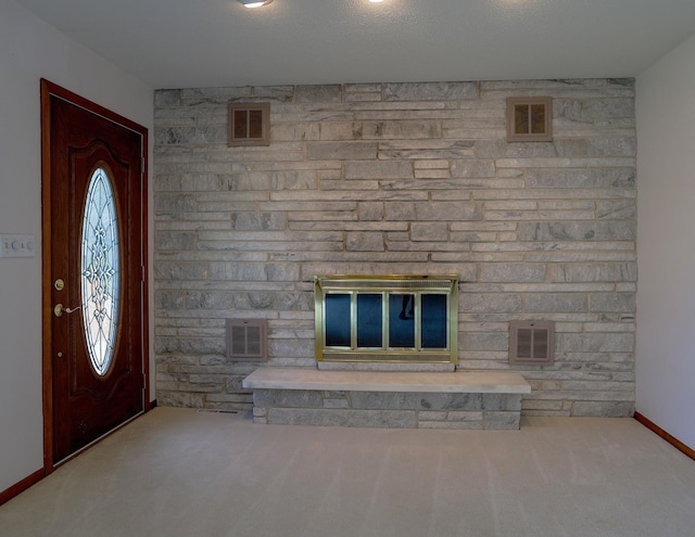 1108 Hillcrest Ct, Chariton, IA 50049 - carpeted foyer entrance with baseboards and a stone fireplace