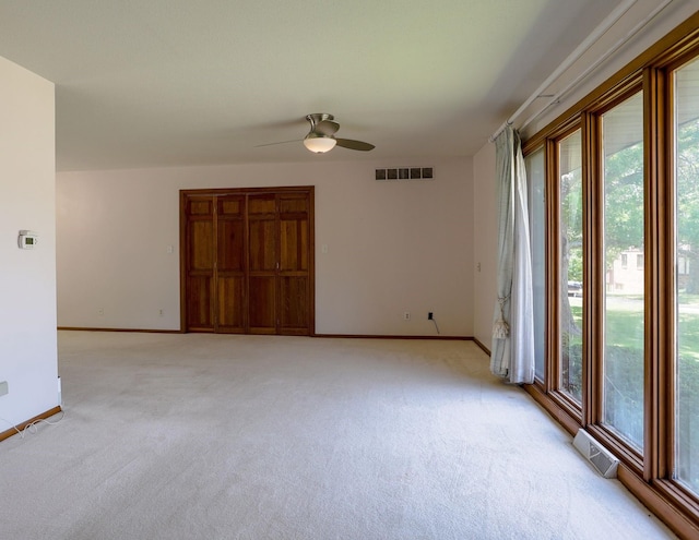 1108 Hillcrest Ct, Chariton, IA 50049 - empty room featuring light carpet and ceiling fan