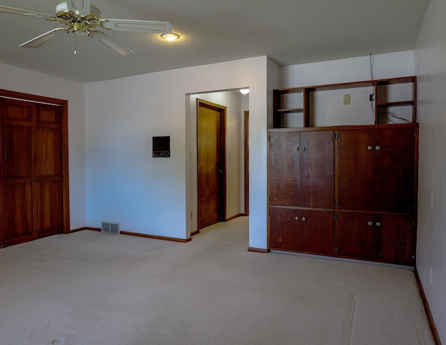 1108 Hillcrest Ct, Chariton, IA 50049 - unfurnished bedroom featuring light colored carpet and a ceiling fan