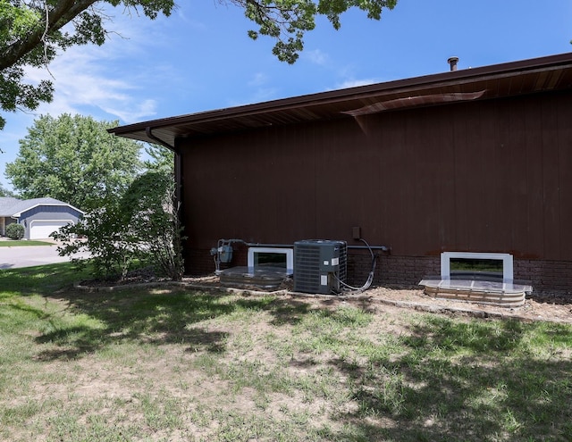 1108 Hillcrest Ct, Chariton, IA 50049 - view of side of property with a central air condition unit and a yard