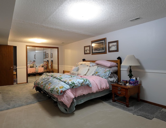 1108 Hillcrest Ct, Chariton, IA 50049 - carpeted bedroom with a closet and a textured ceiling