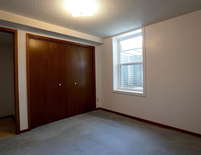 1108 Hillcrest Ct, Chariton, IA 50049 - unfurnished bedroom featuring carpet flooring, a closet, and a textured ceiling