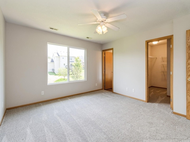 5805 Sterling Trce, Des Moines, IA 50320 - unfurnished bedroom with carpet floors, a spacious closet, and a ceiling fan