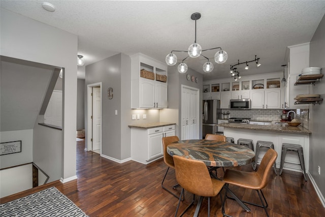 3605 80th St, Urbandale, IA 50322 - dining room with dark wood-type flooring and a textured ceiling