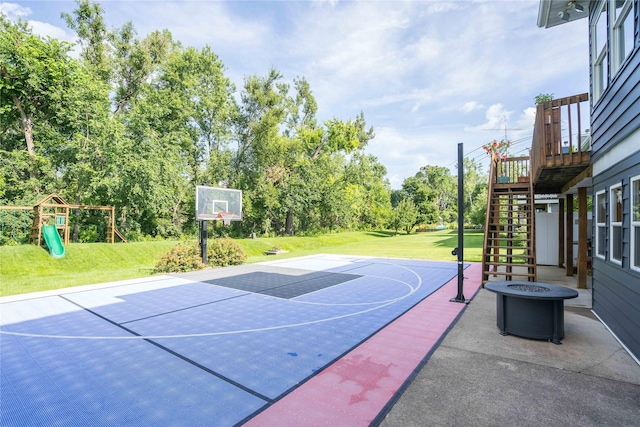 3605 80th St, Urbandale, IA 50322 - view of sport court featuring basketball hoop, a lawn, a playground, and stairway