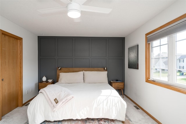 3605 80th St, Urbandale, IA 50322 - bedroom with multiple windows, light colored carpet, a ceiling fan, and a decorative wall