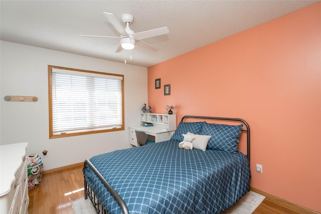 3605 80th St, Urbandale, IA 50322 - bedroom featuring wood finished floors and a ceiling fan