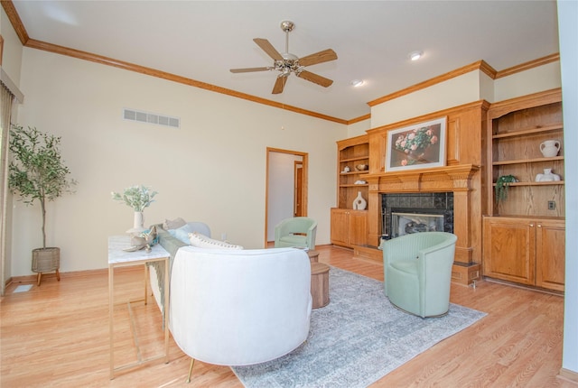 5925 Ep True Pkwy Unit 36, West Des Moines, IA 50266 - living room with a high end fireplace, light wood-type flooring, crown molding, ceiling fan, and recessed lighting