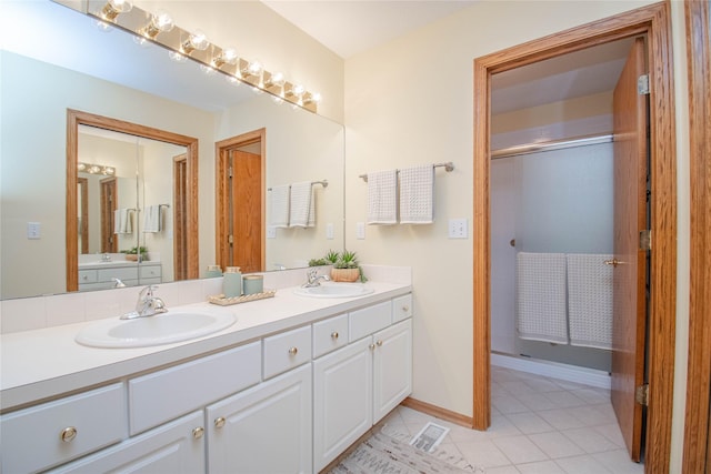 5925 Ep True Pkwy Unit 36, West Des Moines, IA 50266 - bathroom featuring double vanity, tile patterned floors, and a shower with shower door