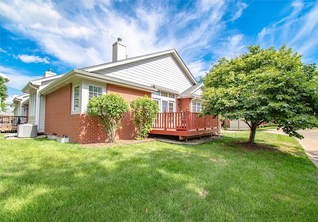 5925 Ep True Pkwy Unit 36, West Des Moines, IA 50266 - rear view of property featuring a chimney, brick siding, a deck, and a yard