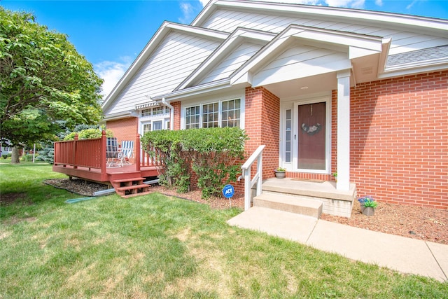 5925 Ep True Pkwy Unit 36, West Des Moines, IA 50266 - view of front facade featuring brick siding, a front lawn, and a wooden deck