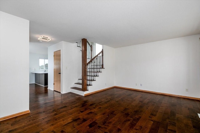 6825 Star View St, Des Moines, IA 50320 - unfurnished room featuring dark wood-style floors and stairs