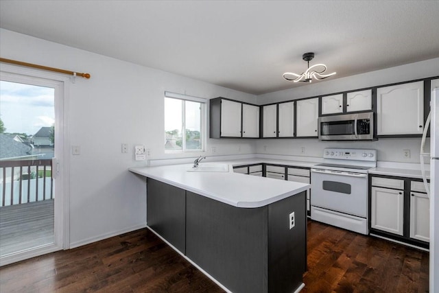 6825 Star View St, Des Moines, IA 50320 - kitchen featuring white electric range oven, stainless steel microwave, a peninsula, a chandelier, and light countertops