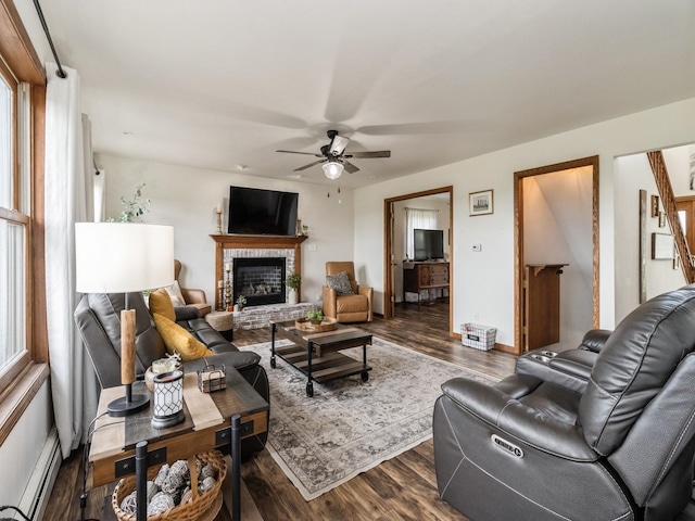 4791 Erbe St, Norwalk, IA 50211 - living area featuring ceiling fan, a fireplace, dark wood finished floors, and a baseboard heating unit