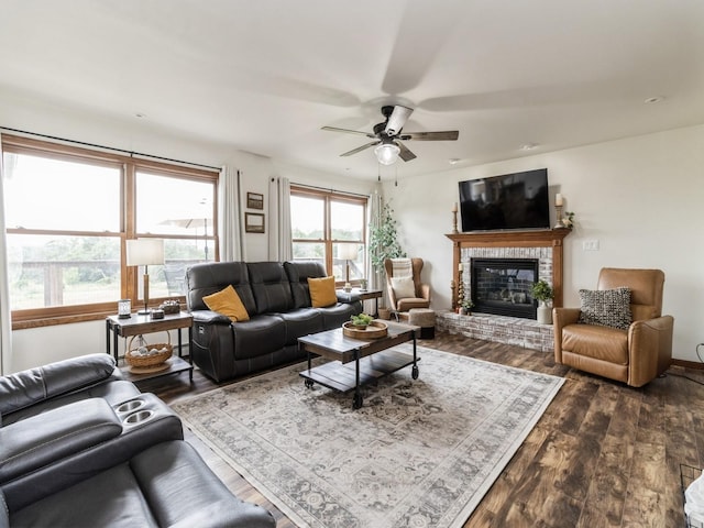 4791 Erbe St, Norwalk, IA 50211 - living room with dark wood finished floors, a brick fireplace, and a ceiling fan