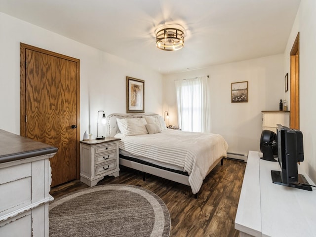 4791 Erbe St, Norwalk, IA 50211 - bedroom featuring dark wood finished floors and a baseboard heating unit
