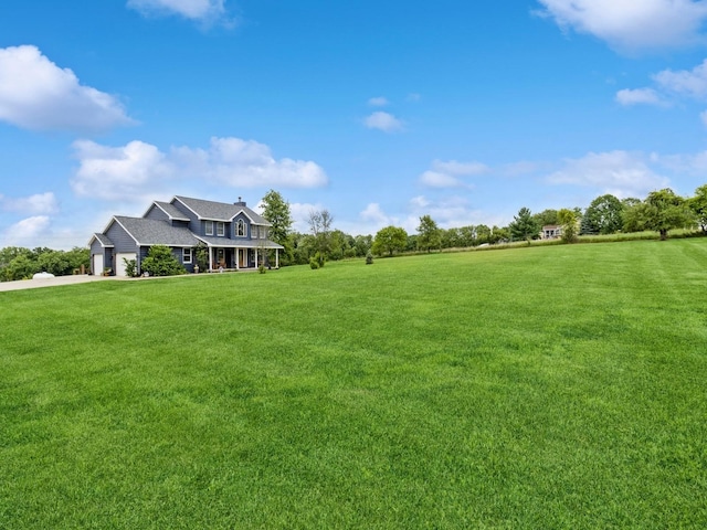4791 Erbe St, Norwalk, IA 50211 - view of green lawn with driveway, covered porch, and a garage