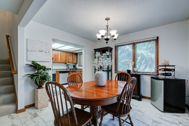 1116 42nd St, West Des Moines, IA 50266 - dining space featuring light marble finish floors, a chandelier, stairway, and a textured ceiling