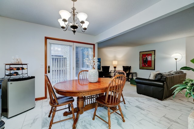 1116 42nd St, West Des Moines, IA 50266 - dining space featuring light marble finish flooring and a chandelier