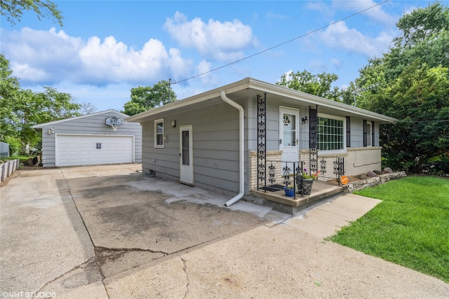 1212 Burnham Ave, Des Moines, IA 50315 - view of front of property with a garage, an outbuilding, and a front lawn