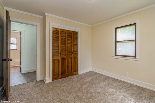 1212 Burnham Ave, Des Moines, IA 50315 - unfurnished bedroom with carpet, ornamental molding, and a closet