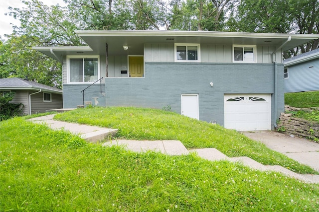 2512 Boston Ave, Des Moines, IA 50310 - view of front of house featuring brick siding, a garage, board and batten siding, and concrete driveway