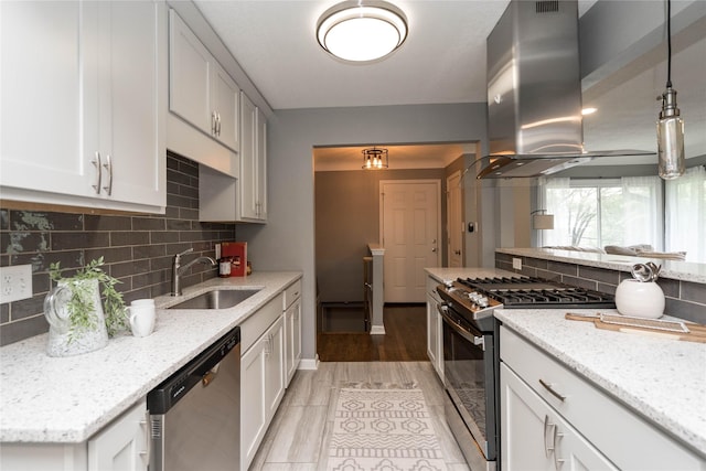 2512 Boston Ave, Des Moines, IA 50310 - kitchen with appliances with stainless steel finishes, island exhaust hood, light stone counters, and backsplash