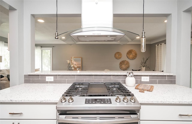 2512 Boston Ave, Des Moines, IA 50310 - kitchen with stainless steel gas stove, island range hood, backsplash, light stone counters, and recessed lighting