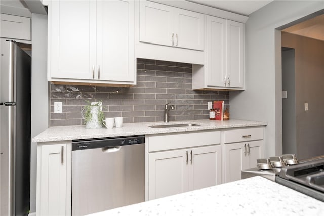2512 Boston Ave, Des Moines, IA 50310 - kitchen featuring appliances with stainless steel finishes, tasteful backsplash, and light stone counters