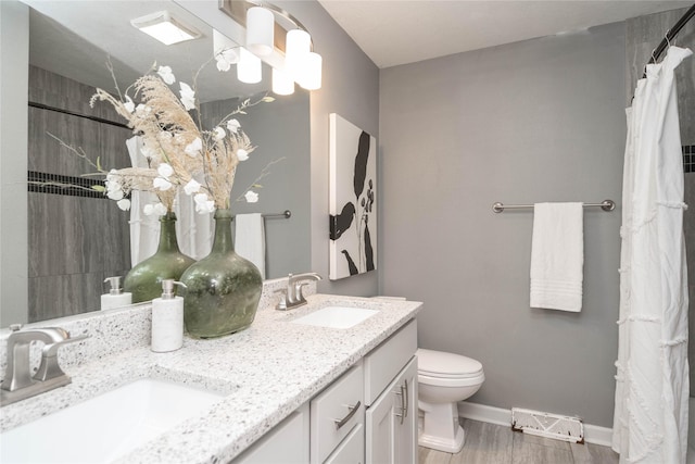 2512 Boston Ave, Des Moines, IA 50310 - bathroom featuring double vanity, a shower with curtain, and wood finished floors