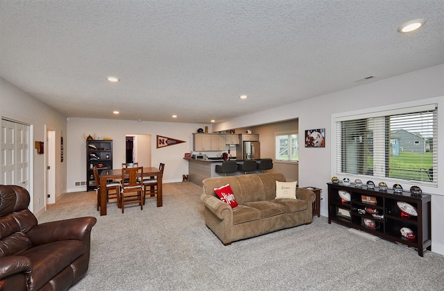 685 Indian Ridge Dr, Waukee, IA 50263 - living room featuring light colored carpet, recessed lighting, and a textured ceiling