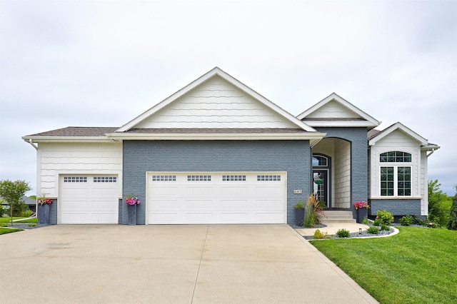 685 Indian Ridge Dr, Waukee, IA 50263 - view of front of home featuring an attached garage, concrete driveway, and a front yard