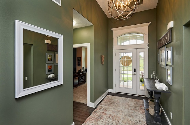 685 Indian Ridge Dr, Waukee, IA 50263 - entryway featuring dark wood-type flooring, a chandelier, and a high ceiling
