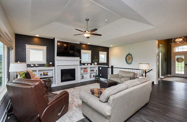 685 Indian Ridge Dr, Waukee, IA 50263 - living room with wood finished floors, a fireplace, a raised ceiling, and a chandelier