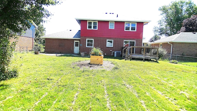 623 E 18th St N, Newton, IA 50208 - rear view of house featuring a fenced backyard, a wooden deck, and brick siding