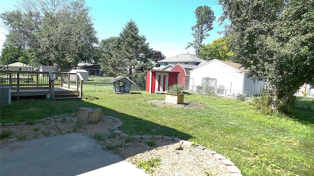 623 E 18th St N, Newton, IA 50208 - view of green lawn with a storage shed and a wooden deck