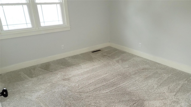 623 E 18th St N, Newton, IA 50208 - spare room featuring carpet and baseboards
