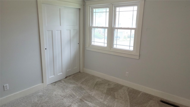 623 E 18th St N, Newton, IA 50208 - unfurnished bedroom featuring carpet and a closet