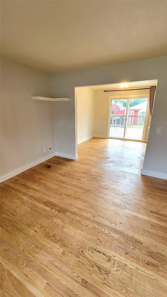 623 E 18th St N, Newton, IA 50208 - empty room with light wood-style flooring and baseboards