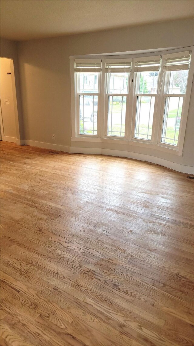 623 E 18th St N, Newton, IA 50208 - spare room with baseboards and light wood-style flooring
