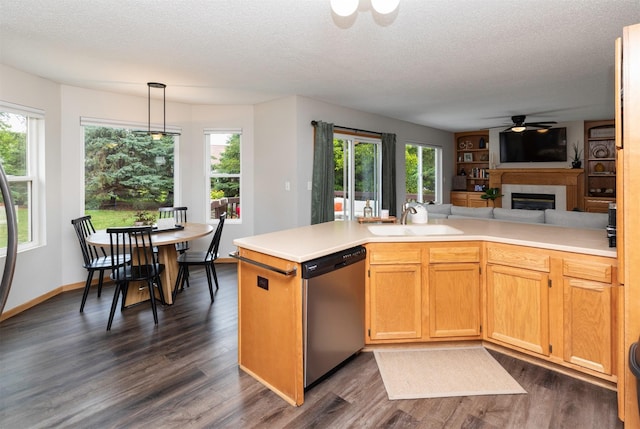 14449 Briarwood Ln, Urbandale, IA 50323 - kitchen featuring dishwasher, dark wood-type flooring, a glass covered fireplace, a ceiling fan, and a textured ceiling