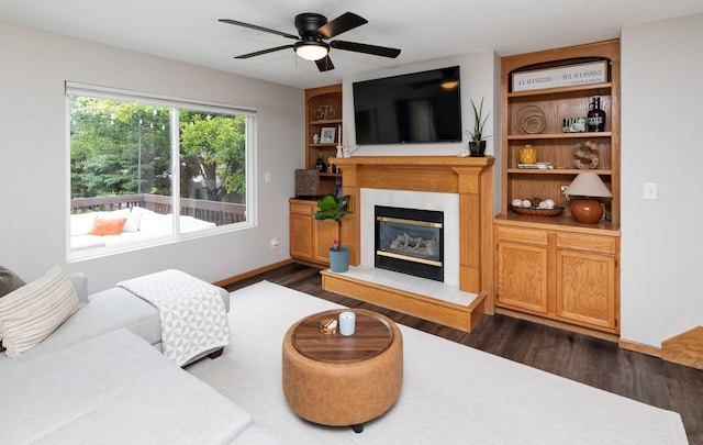 14449 Briarwood Ln, Urbandale, IA 50323 - living room featuring dark wood finished floors, ceiling fan, and a fireplace