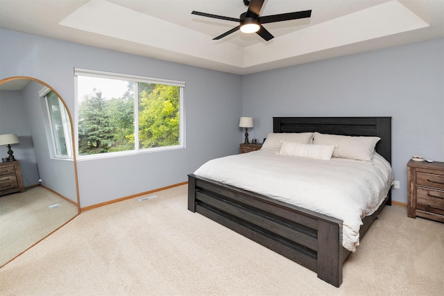14449 Briarwood Ln, Urbandale, IA 50323 - carpeted bedroom featuring a raised ceiling and ceiling fan