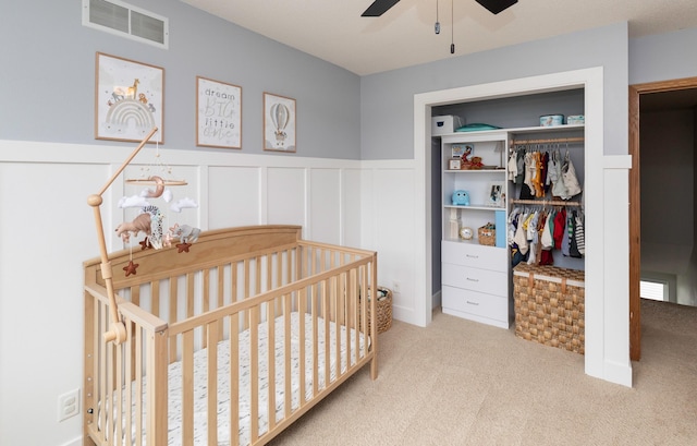 14449 Briarwood Ln, Urbandale, IA 50323 - bedroom with carpet flooring, a closet, a wainscoted wall, a decorative wall, and a nursery area