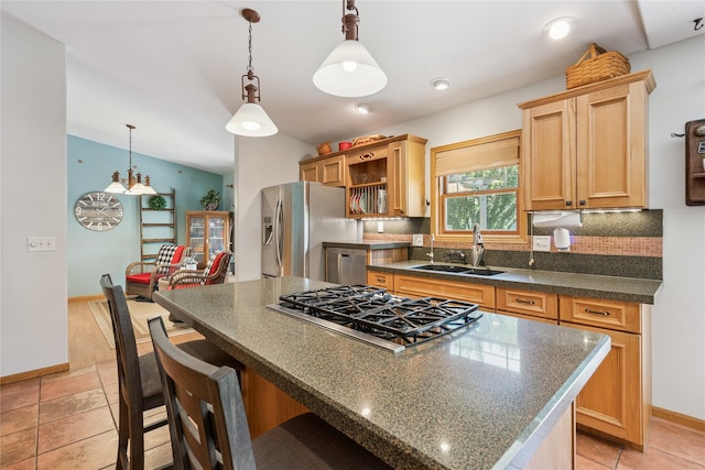 7 Hobart Pl, Grinnell, IA 50112 - kitchen with stainless steel appliances, a center island, decorative backsplash, vaulted ceiling, and a kitchen breakfast bar