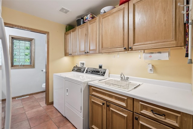 7 Hobart Pl, Grinnell, IA 50112 - laundry area featuring cabinet space, independent washer and dryer, and light tile patterned floors