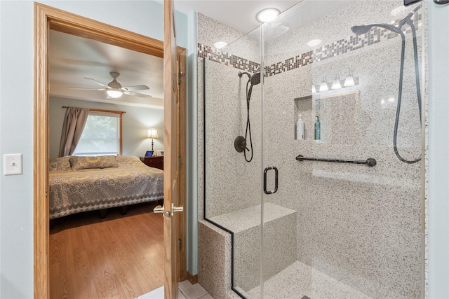 7 Hobart Pl, Grinnell, IA 50112 - ensuite bathroom with a stall shower, ceiling fan, and wood finished floors
