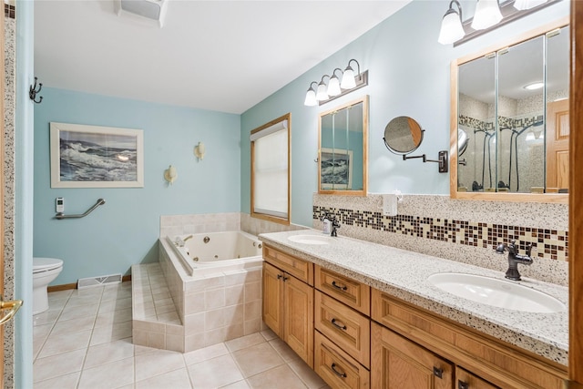 7 Hobart Pl, Grinnell, IA 50112 - bathroom with a jetted tub, tile patterned floors, double vanity, a shower stall, and tasteful backsplash