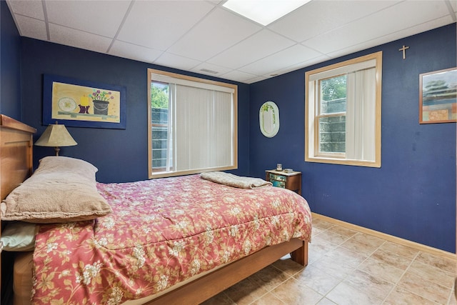 7 Hobart Pl, Grinnell, IA 50112 - bedroom with a paneled ceiling and tile patterned floors